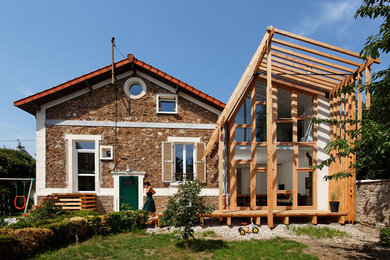 Small contemporary two-storey exterior in Paris with wood siding.