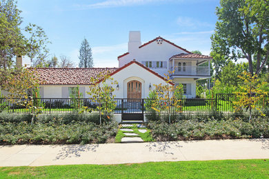 Tuscan white two-story exterior home photo in Los Angeles