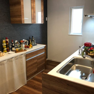 Design ideas for an industrial single-wall open plan kitchen in Other with glass-front cabinets, distressed cabinets, composite countertops, white splashback, stainless steel appliances, plywood flooring, a breakfast bar, brown floors and white worktops.