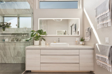 Inspiration for a mid-sized contemporary master multicolored tile and porcelain tile porcelain tile, gray floor, single-sink and vaulted ceiling bathroom remodel in San Diego with flat-panel cabinets, beige cabinets, a one-piece toilet, gray walls, a vessel sink, quartz countertops, gray countertops, a niche and a built-in vanity