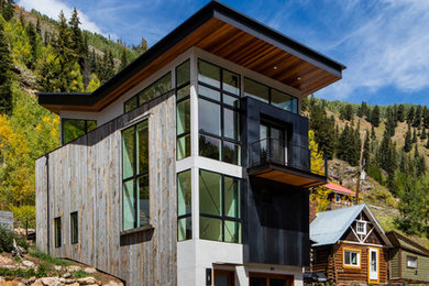 Inspiration for a large modern three-story mixed siding exterior home remodel in Denver with a shed roof