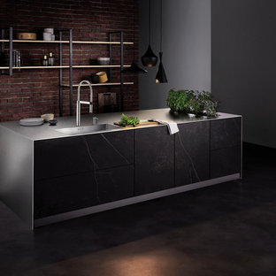 Large industrial open concept kitchen appliance - Inspiration for a large industrial concrete floor and gray floor open concept kitchen remodel in Other with an integrated sink, flat-panel cabinets, brown cabinets, stainless steel countertops, red backsplash, an island, gray countertops and brick backsplash