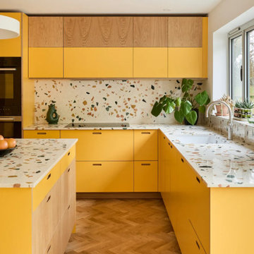 Sunshine yellow kitchen with statement resin terrazzo