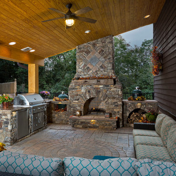 Outdoor fireplace with grill island and big green egg