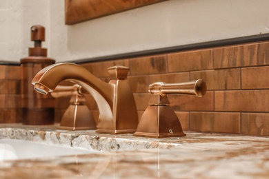 Brown tile and metal tile bathroom photo in Phoenix with beige walls and an integrated sink