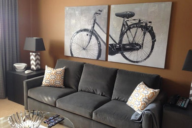 Family room - mid-sized contemporary enclosed carpeted family room idea in Toronto with brown walls and no fireplace