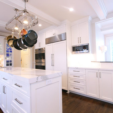 Hanging Microwave Next To Paneled Refrigerator
