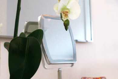 Bathroom - mid-sized modern master glass sheet and white tile bathroom idea in Montreal with flat-panel cabinets, white cabinets, a two-piece toilet, a vessel sink and laminate countertops