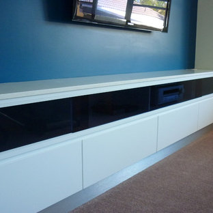 Example of a large trendy enclosed carpeted home theater design in Wollongong with blue walls and a wall-mounted tv