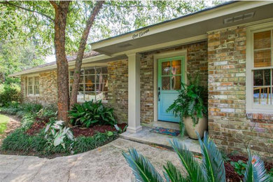 Mid-sized elegant brown one-story brick house exterior photo in New Orleans with a hip roof and a shingle roof