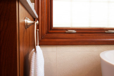 Large elegant master beige tile and ceramic tile ceramic tile, beige floor and double-sink bathroom photo in Other with shaker cabinets, dark wood cabinets, a two-piece toilet, beige walls, an undermount sink, quartz countertops, a hinged shower door, white countertops and a built-in vanity