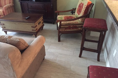 Example of a mid-sized arts and crafts formal and open concept ceramic tile living room design in Miami with green walls and a tv stand