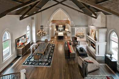 Example of a huge classic open concept dark wood floor living room design in Denver with beige walls, a standard fireplace, a stone fireplace and no tv