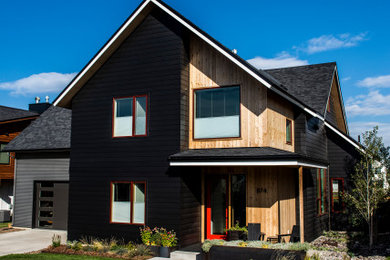 Mid-sized contemporary black two-story mixed siding exterior home idea with a shingle roof and a black roof