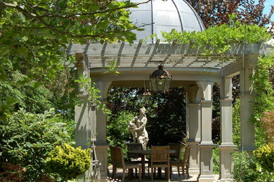 Patio - large traditional courtyard gravel patio idea in Boston with a pergola