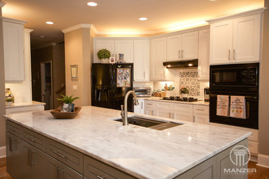 Example of a mid-sized transitional kitchen design in Atlanta with an undermount sink, shaker cabinets, white cabinets, marble countertops, white backsplash, subway tile backsplash, black appliances, an island and white countertops