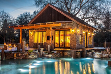 Mid-sized mountain style gray one-story stone exterior home photo in Other with a shingle roof