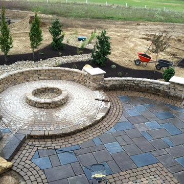 Slab patio with manufactured natural stone walls