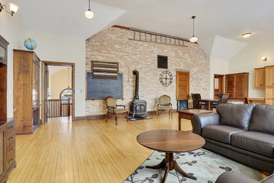 Large trendy formal and open concept light wood floor living room photo in Other with white walls, a wood stove, a metal fireplace and no tv