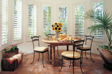 Inspiration for a small timeless terra-cotta tile and brown floor enclosed dining room remodel in San Francisco with white walls and no fireplace