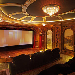 Inspiration for a mediterranean enclosed carpeted and green floor home theater remodel in Minneapolis with brown walls and a projector screen