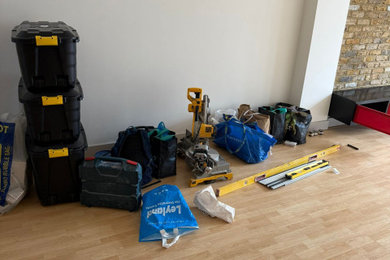 Photo of a small modern open plan games room in London with brick walls.