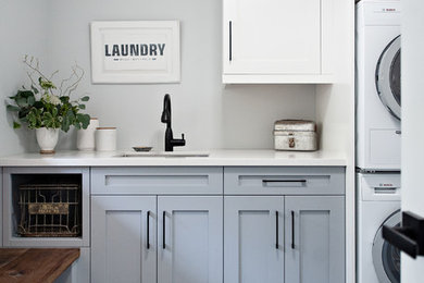 Example of a transitional laundry room design in Toronto