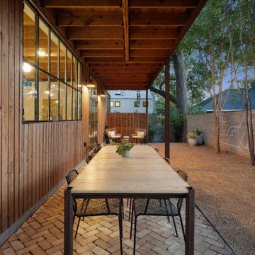 Modern Outdoor Dining Beneath Exposed Wood Beams