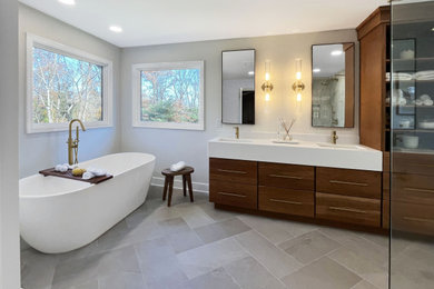 Example of a large transitional master beige tile and marble tile porcelain tile, gray floor and double-sink bathroom design in Philadelphia with flat-panel cabinets, brown cabinets, a one-piece toilet, beige walls, an undermount sink, quartzite countertops, a hinged shower door, white countertops and a built-in vanity