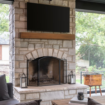 A stunning home exterior addition featuring coffered wood-slat ceilings, a cozy