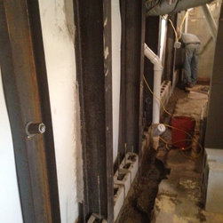 Tie backs installed and footer and reinforced wall in front between steel buttre - Products