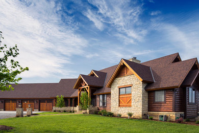 Large rustic beige two-story mixed siding exterior home idea in Wichita with a shingle roof