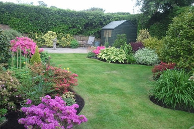 This is an example of a mid-sized traditional full sun front yard landscaping in Denver.