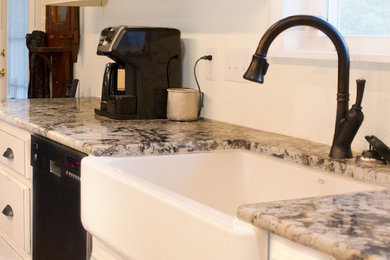 Inspiration for a mid-sized timeless l-shaped dark wood floor and brown floor open concept kitchen remodel in Little Rock with a farmhouse sink, raised-panel cabinets, white cabinets, granite countertops and stainless steel appliances