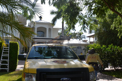 Huge mediterranean white two-story stucco house exterior idea in Orlando with a metal roof