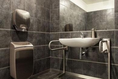 Inspiration for a mid-sized transitional 3/4 multicolored tile, gray tile and ceramic tile ceramic tile and gray floor doorless shower remodel in Cleveland with a two-piece toilet, a wall-mount sink and gray walls