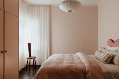 Transitional bedroom in Adelaide with pink walls, dark hardwood floors and brown floor.