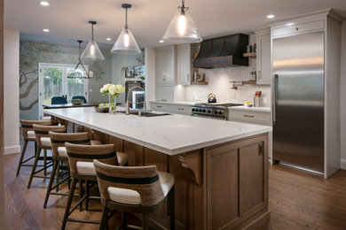 Inspiration for a huge timeless galley medium tone wood floor and brown floor eat-in kitchen remodel in San Francisco with an undermount sink, beaded inset cabinets, gray cabinets, quartz countertops, white backsplash, quartz backsplash, stainless steel appliances, an island and white countertops