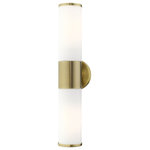 Livex Lighting - Antique Brass Contemporary, Minimal, Urban, Clean Vanity Sconce - Add a dash of character and radiance to your home with this vanity sconce. This two-light fixture from the Lindale Collection features an antique brass finish with two satin opal white glass cylinder shades on either side. The clean lines of the back plate complement the cylindrical glass shades adorned with detailed trim at the end of each glass creating a minimal, sleek, urban look that works well in most decors. This fixture adds upscale charm and contemporary aesthetics to your home.
