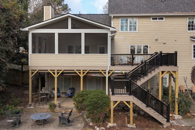 Screened-in back porch idea in Atlanta with decking and a roof extension