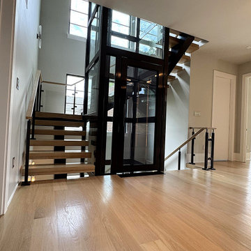 Project #136 | Modern Floating Staircase Encircling Glass Elevator