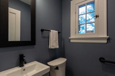 Powder room - small traditional mosaic tile floor and gray floor powder room idea in Chicago with shaker cabinets, gray cabinets, a two-piece toilet, blue walls, white countertops and a freestanding vanity