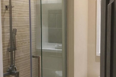 Inspiration for a mid-sized transitional 3/4 beige tile porcelain tile and brown floor bathroom remodel in Toronto with flat-panel cabinets, white cabinets, a one-piece toilet, beige walls and an integrated sink