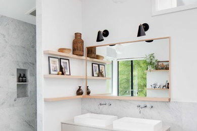Bathroom - large modern kids' white tile and marble tile cement tile floor and black floor bathroom idea in Los Angeles with flat-panel cabinets, beige cabinets, a two-piece toilet, white walls and a vessel sink