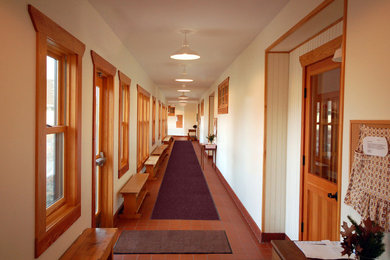 This is an example of a contemporary hallway in Minneapolis with white walls and ceramic floors.