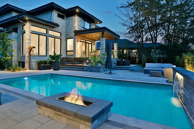 Pool - large modern backyard rectangular natural pool idea in Montreal