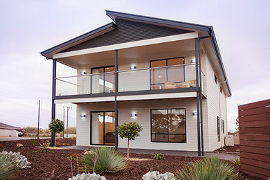 This is an example of a large contemporary two-storey house exterior in Adelaide.