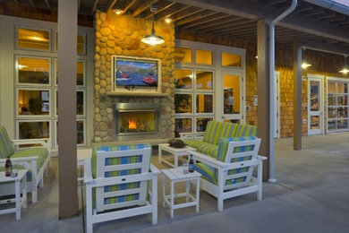Inspiration for a large arts and crafts backyard patio in Seattle with a fire feature, concrete slab and a roof extension.