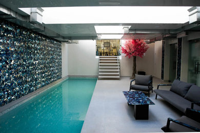 Design ideas for a contemporary rectangular swimming pool in London with tiled flooring.