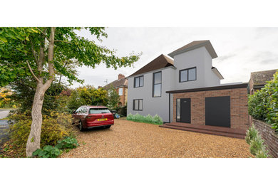 Large and white modern two floor render semi-detached house in Cambridgeshire with a pitched roof and a tiled roof.